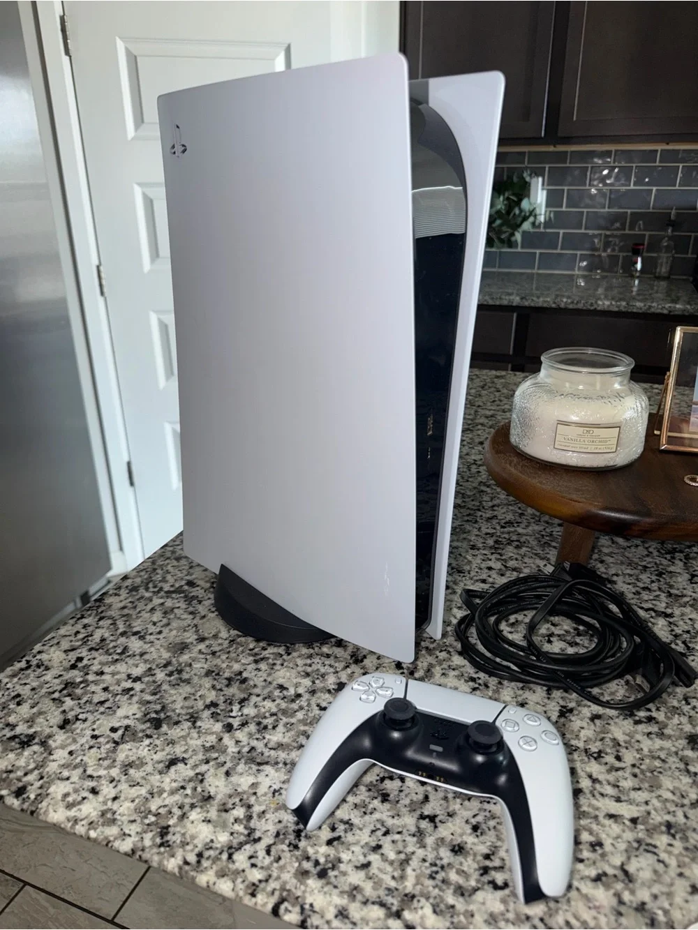 PS5 with HDMI/ power cords, controller, and stand.